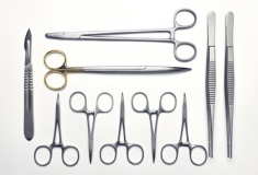 Set of various surgical instruments on a white background